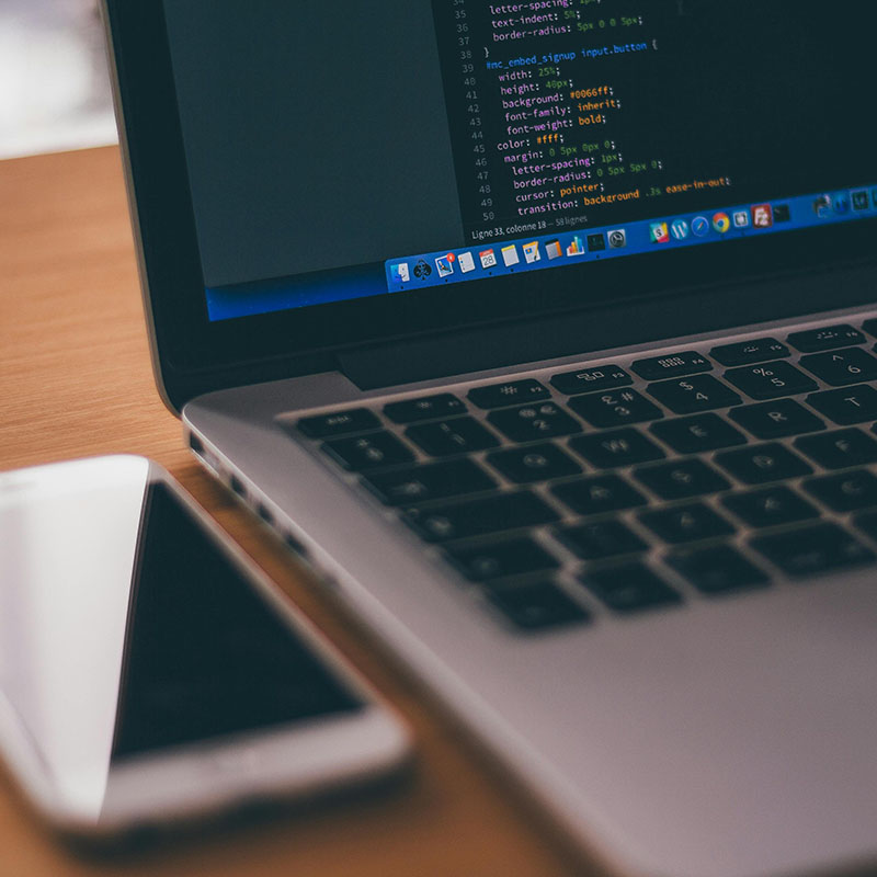 Photo of a laptop and cell phone - Gauntlet Creative Hudson MA USA Website Design Audio Engineering Podcast Production Media to Digital Graphic Design Media Solutions